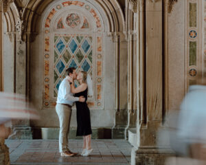 Wedding Photographer, in a church a man and woman kiss and embrace